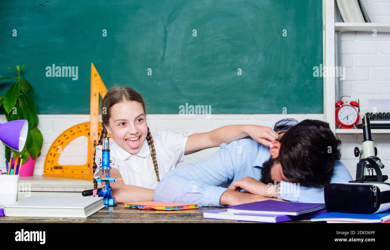 tired father and daughter study in classroom. education and knowledge. biology chemistry lesson. bearded man teacher with small girl in classroom. back to school. math geometry. learning geometry. Stock Photo