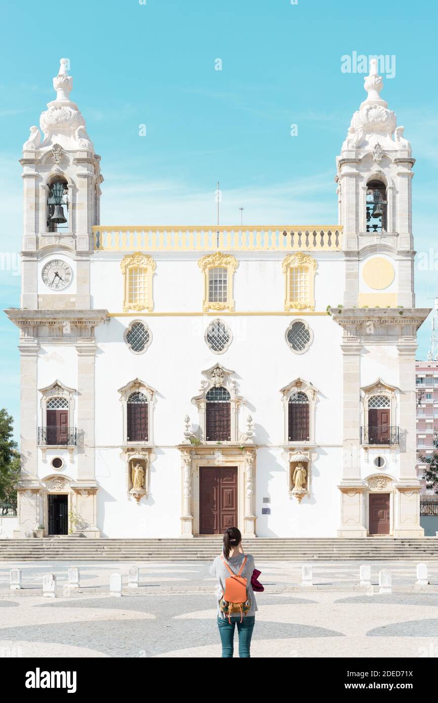 Faro Portugal  3 Apr 2018 Young woman traveler in front of Cathedral  church of Carmo in Old Town Stock Photo