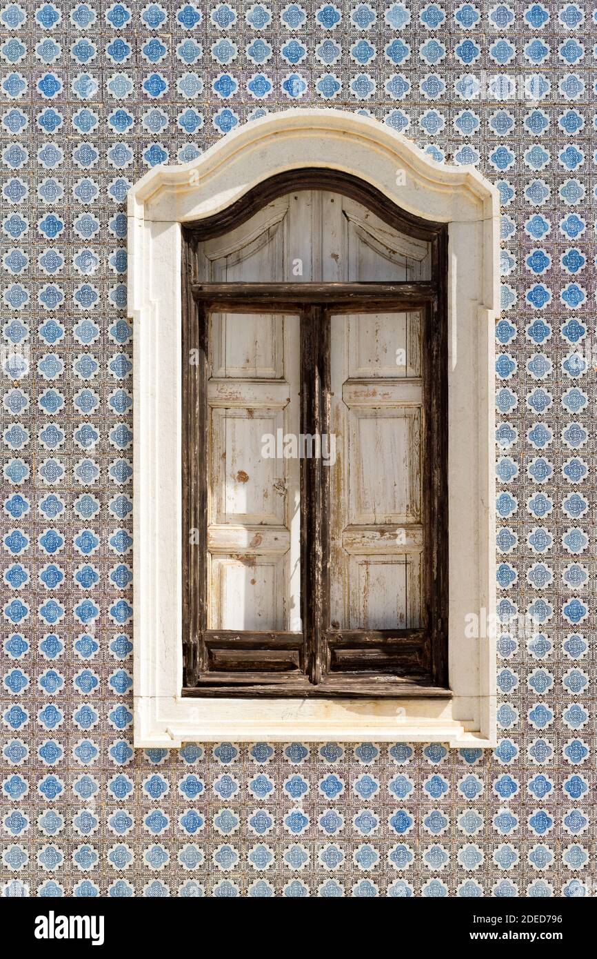 Window on a tile painted wall Stock Photo