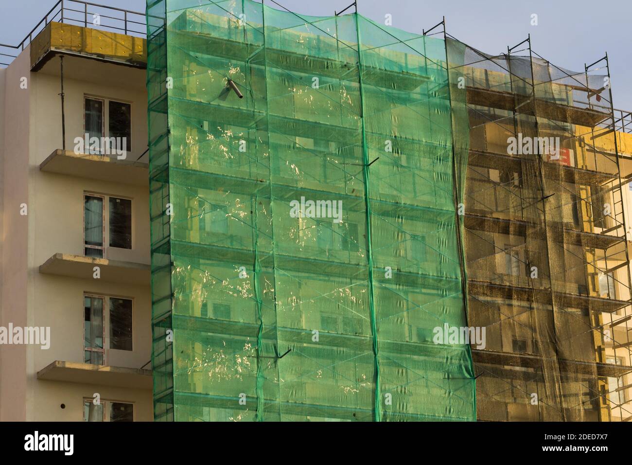 building under construction in scaffolding Stock Photo - Alamy