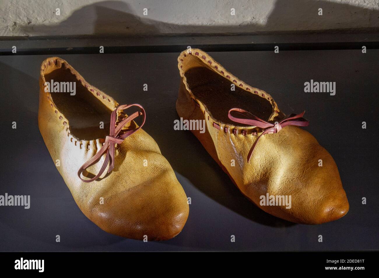 Replicas of the leather shoes were placed at the feet of the body