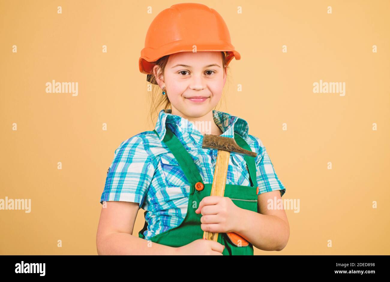small girl repairing with hammer in workshop. Child care development ...