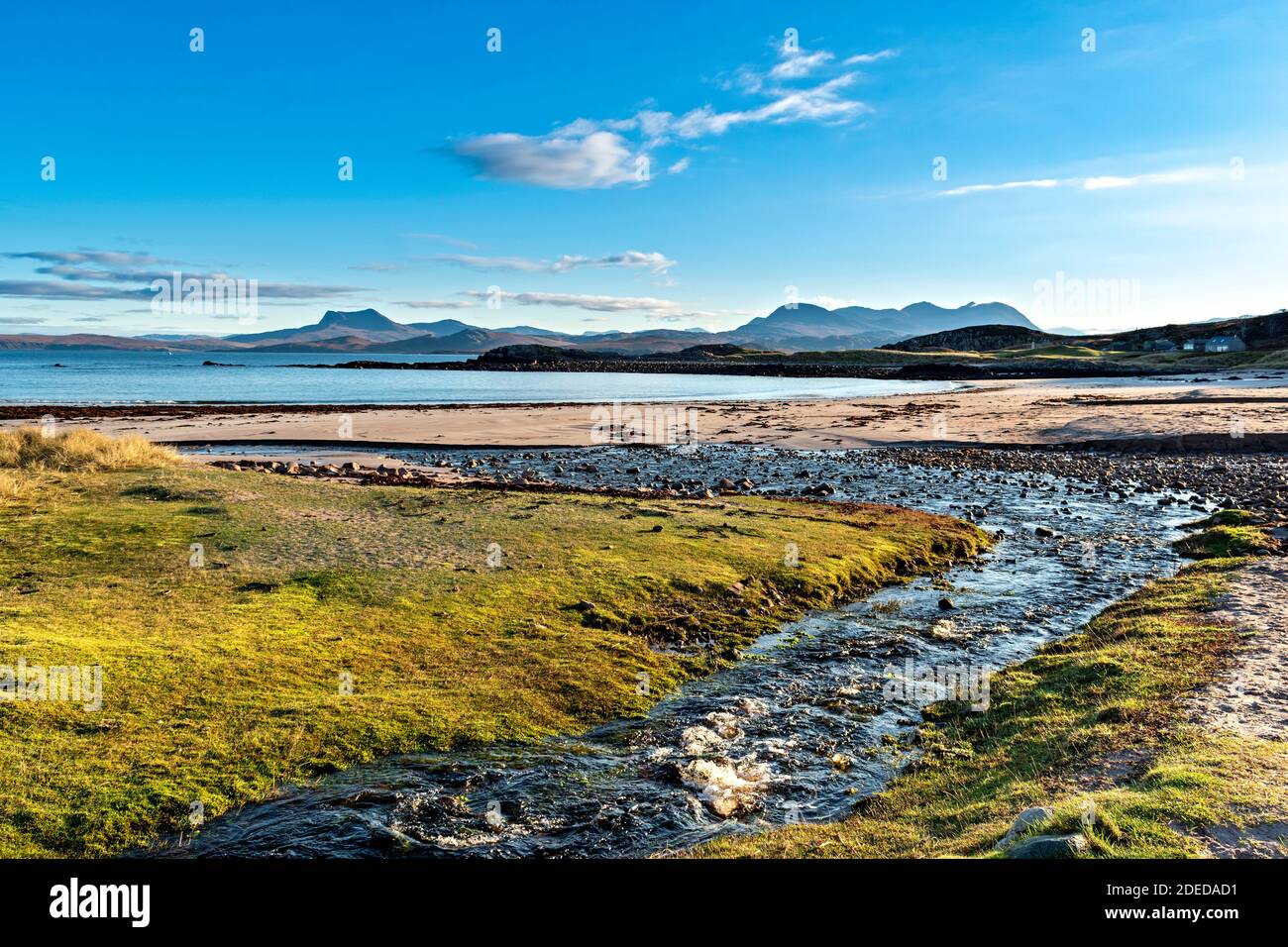 MELLON UDRIGLE ROSS-SHIRE HIGHLANDS SCOTLAND MORNING SUNSHINE SMALL STREAM LEADING TO THE BEACH AND VIEW TO MOUNTAIN RANGES Stock Photo