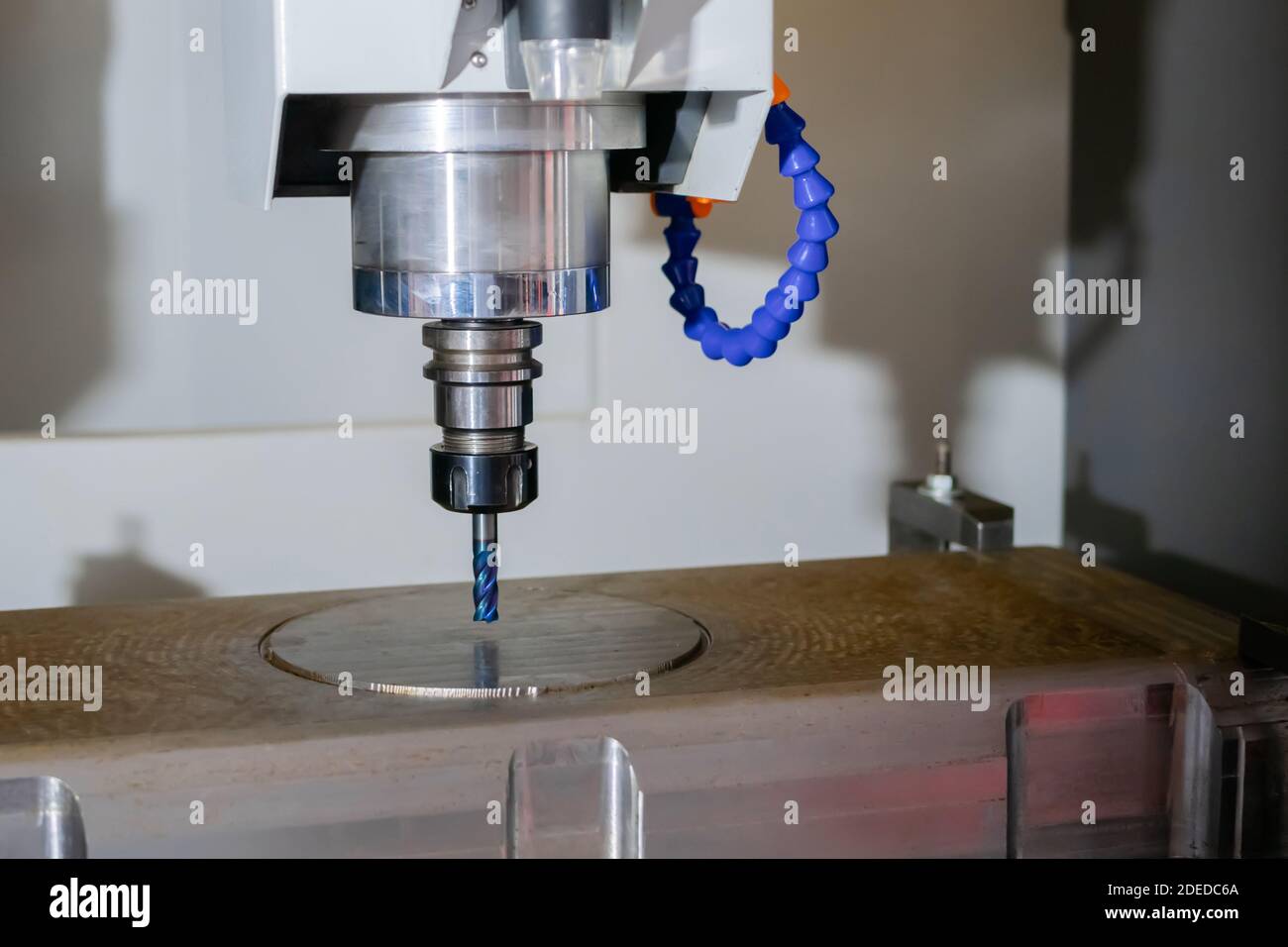 Turning milling machine cutting metal workpiece at factory Stock Photo