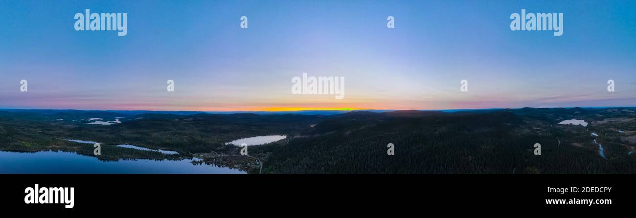 Panorama view over forest wilderness in Scandinavia at sunset. Stock Photo