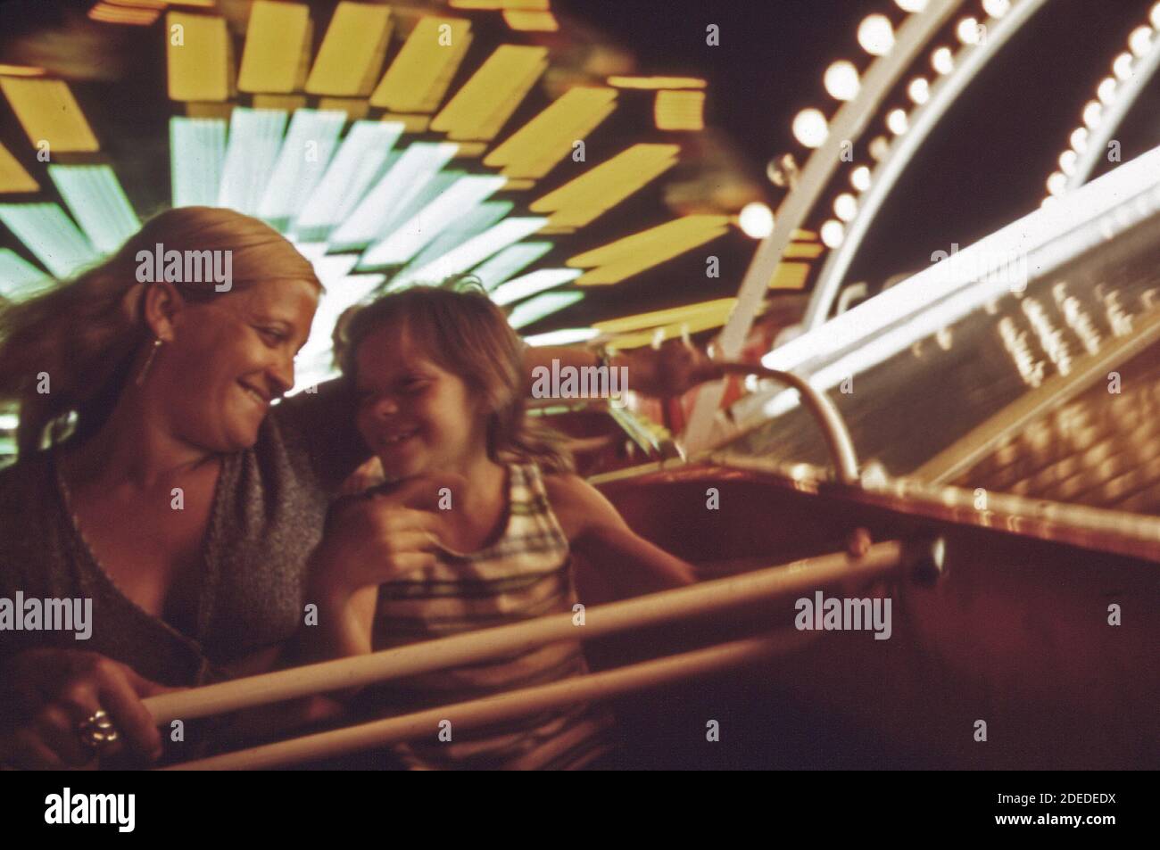 "1970s Photos (1973) -  Wanda shemwell and her daughter susan (9) ride on the Trabant; a german amusement ride at ""Fun City"" on ""The Strip."" mrs shemwell and susan are frequent visitors to ""Fun City"". The shemwells have their own home on the lake  (Lake of the Ozarks Missouri area) " Stock Photo