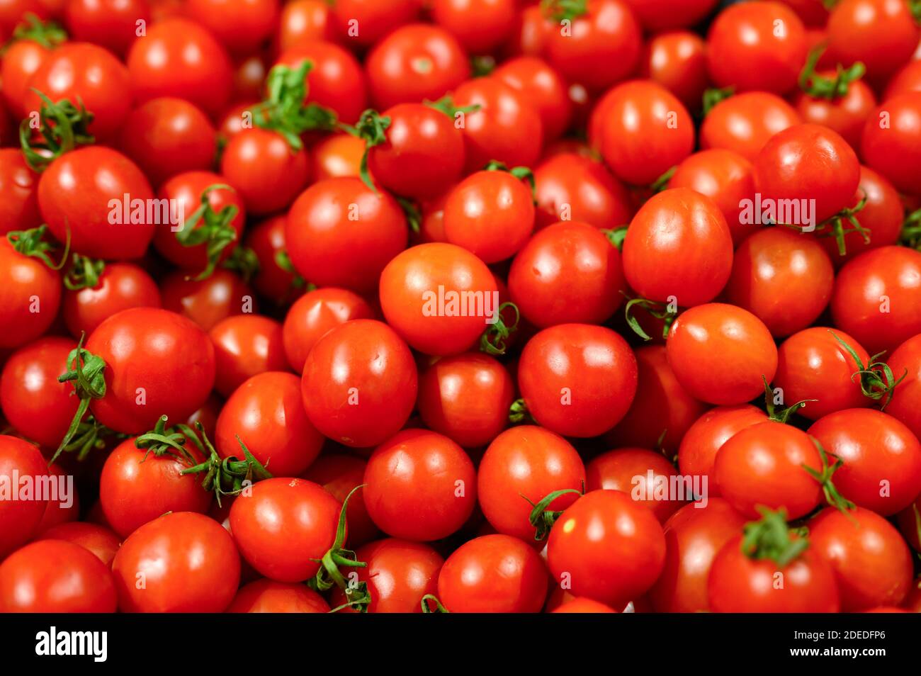 a pile of vegetables red mini tomatoes as background Stock Photo - Alamy