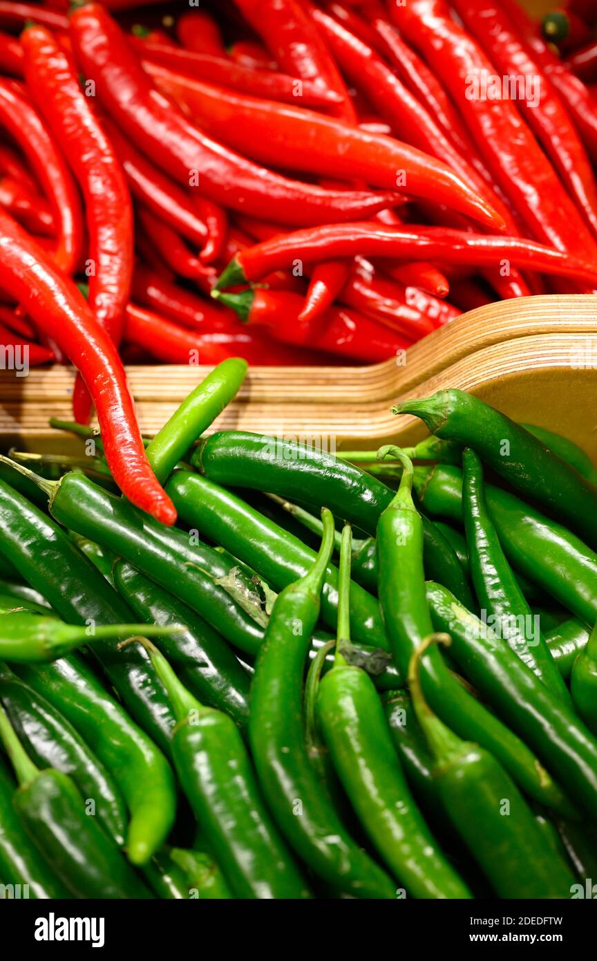 a pile of vegetables red and green hot chili peppers as background ...