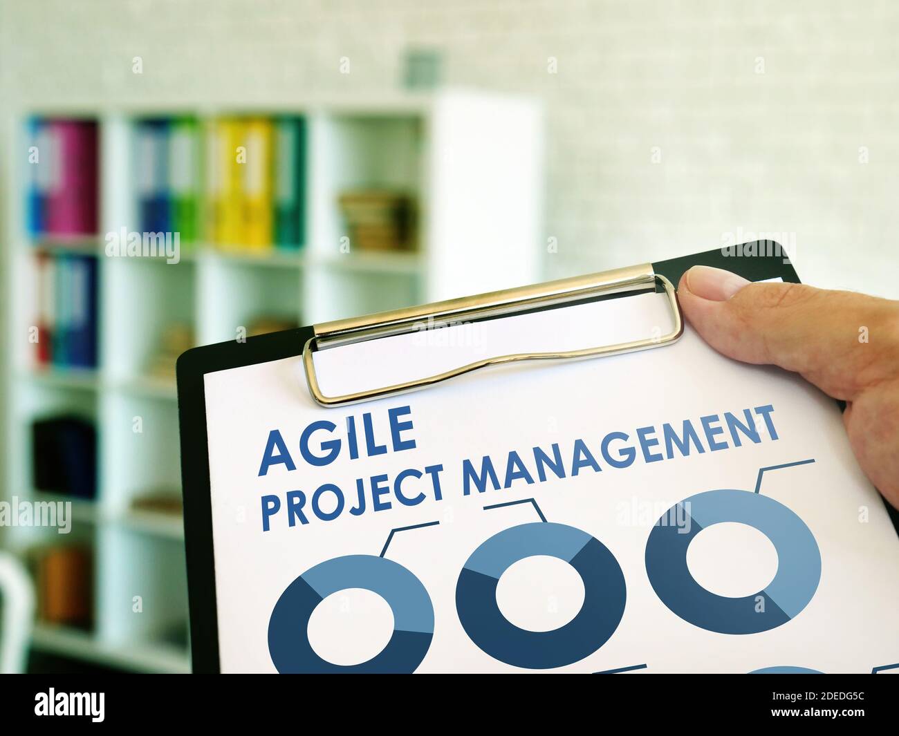 Man reads Agile Project Management information in the book. Stock Photo