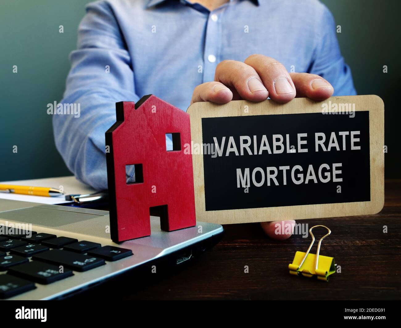 The realtor offers Variable rate mortgage and holds plate. Stock Photo