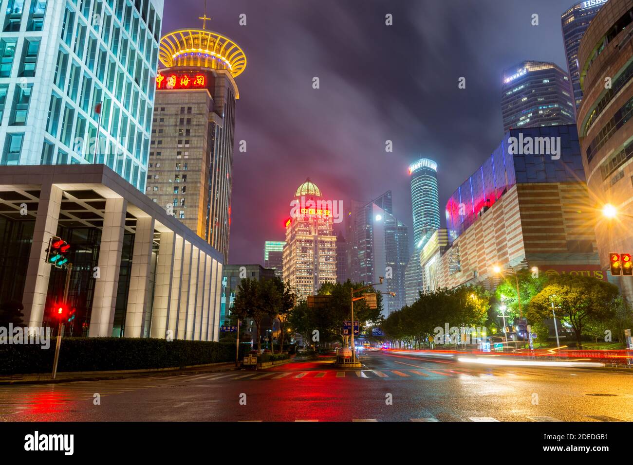 Night view of the skycrapers at Pudong new district in Shanghai at a cloudy day after raining with golden light in Shanghai, China Stock Photo