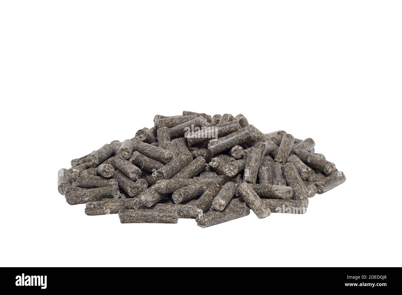 A pile of dark animal feed pellets isolated on a white background. The