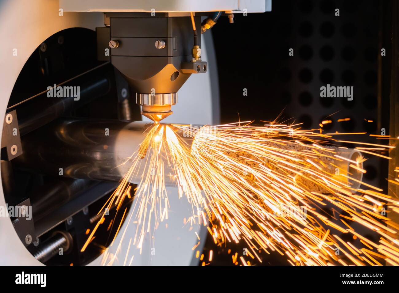 Laser cutting machine working with cylindrical metal workpiece with sparks  Stock Photo - Alamy
