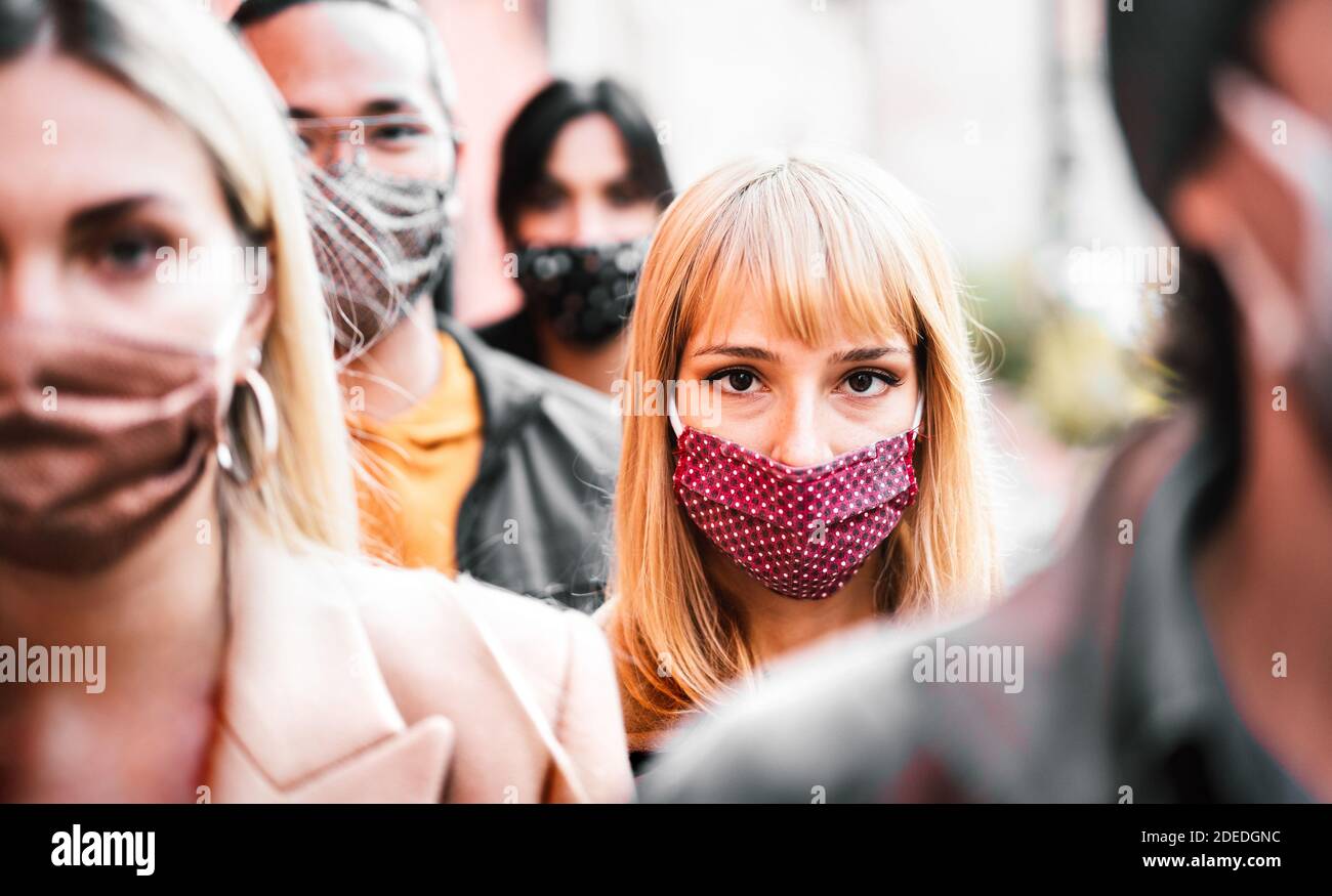 Urban crowd of citizens walking on city street covered by face mask - New normal society concept with people on worried anxiety mood Stock Photo