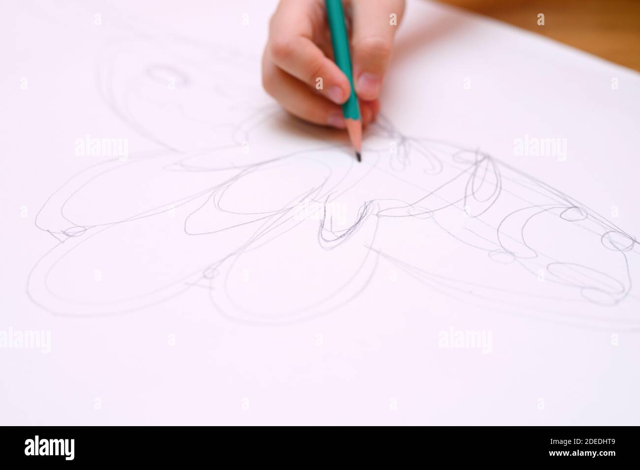 kids hobby. child hand draws sketch with a pencil on white paper Stock Photo