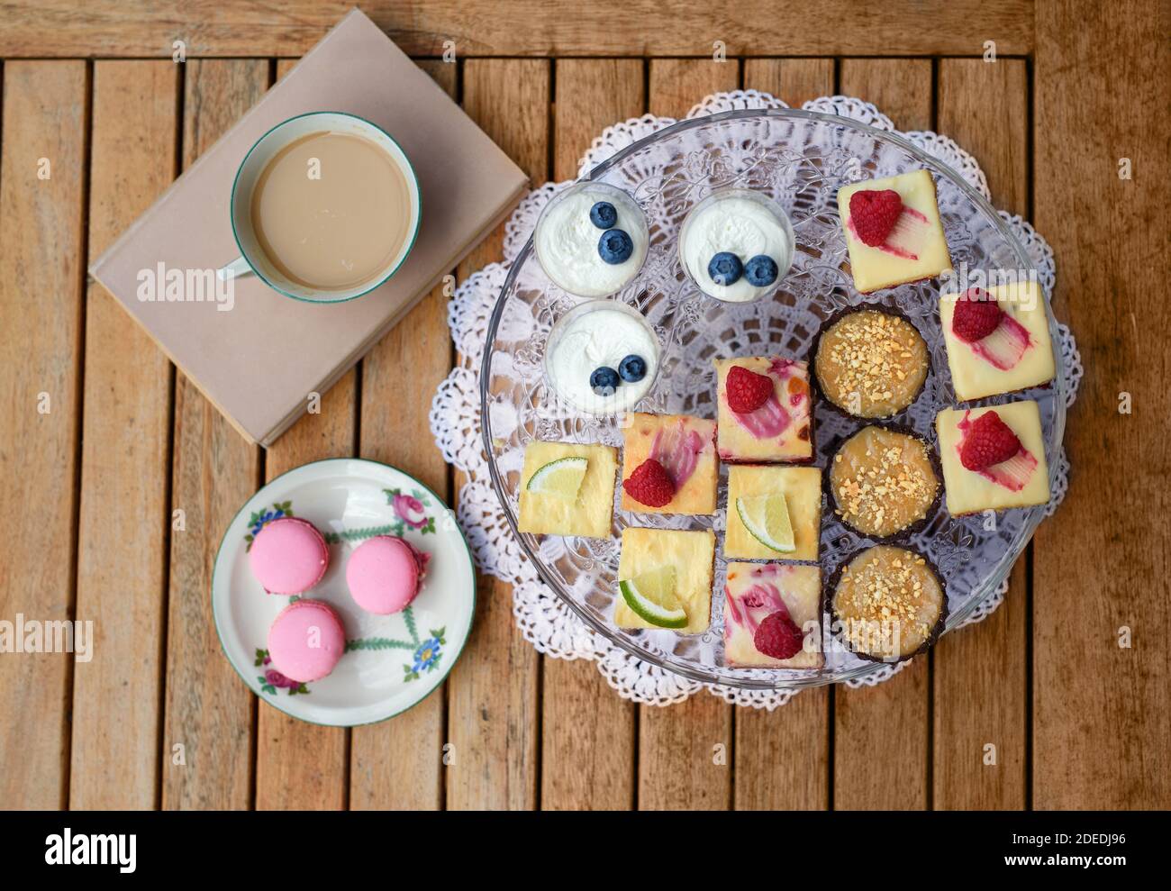 Top view of selection of colorful and delicious cake desserts on tray on table. Stock Photo