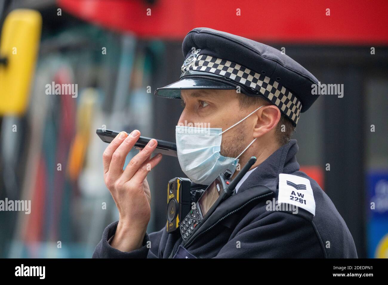 Policeman masked on his phone in London today  30.11.20    picture by Gavin Rodgers/ Pixel8000 Stock Photo
