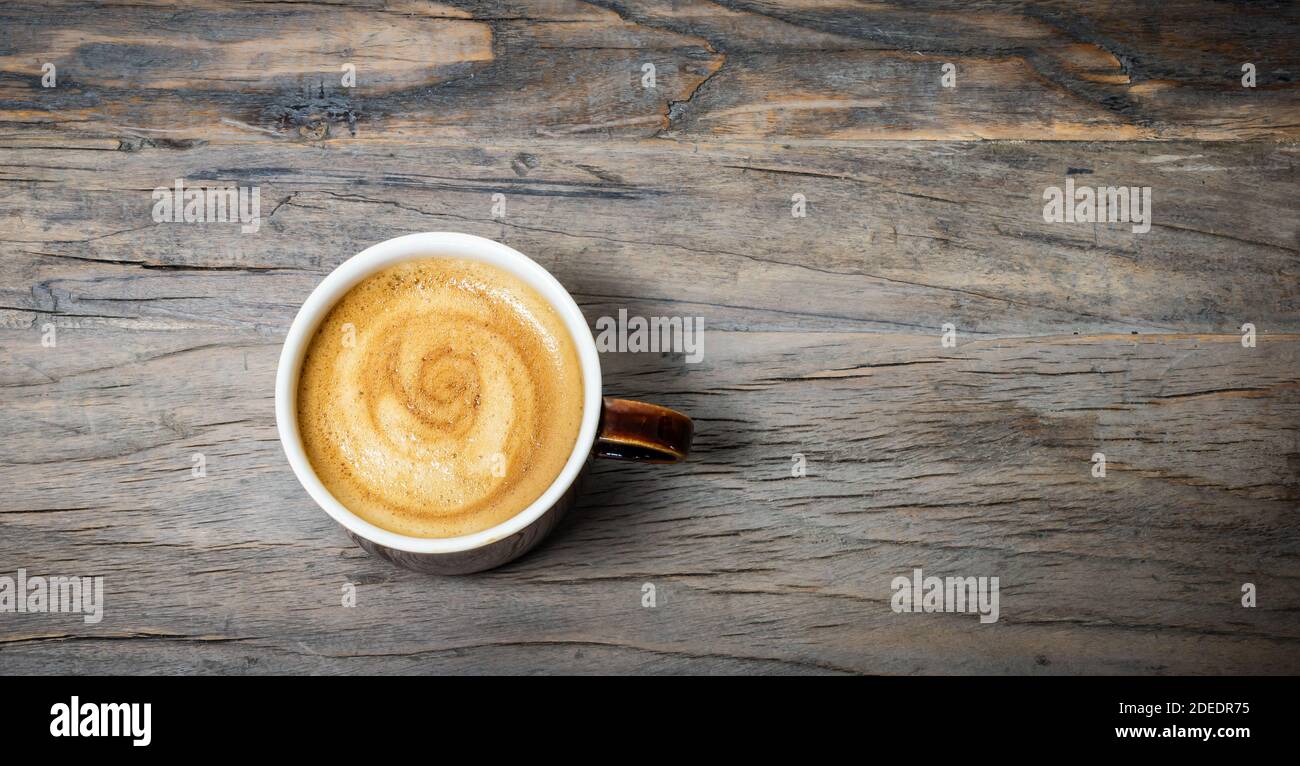 Cup of espresso coffee on wooden table. Top view. Stock Photo