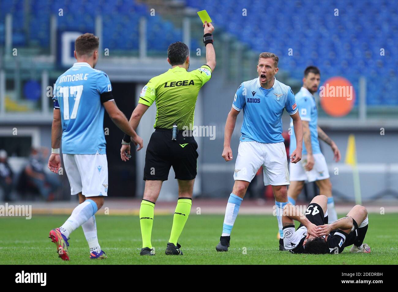 The referee Gianluca Aureliano shows yellow card to Lucas Leiva of Lazio (R), who reacts during the Italian championship Se / LM Stock Photo