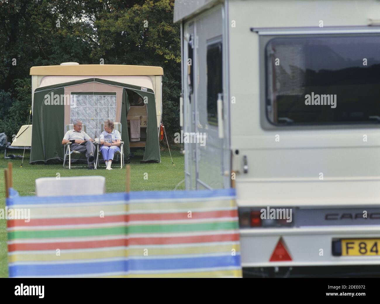 Elderly couple relaxing at a caravan park. Cambridgeshire. England. UK Stock Photo