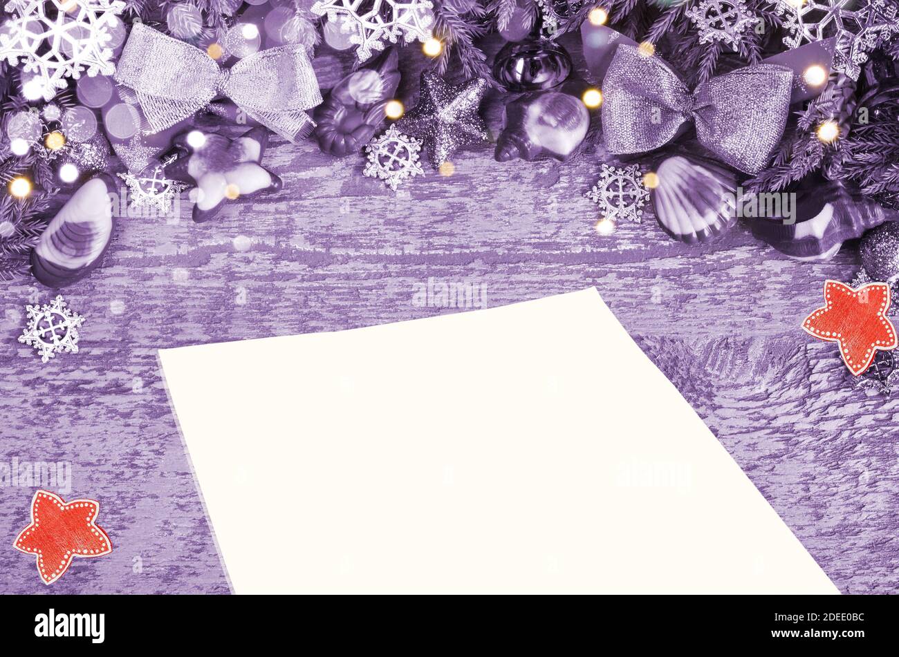 Christmas, purple-tinted background with bokeh . Blank sheet of paper for text Stock Photo