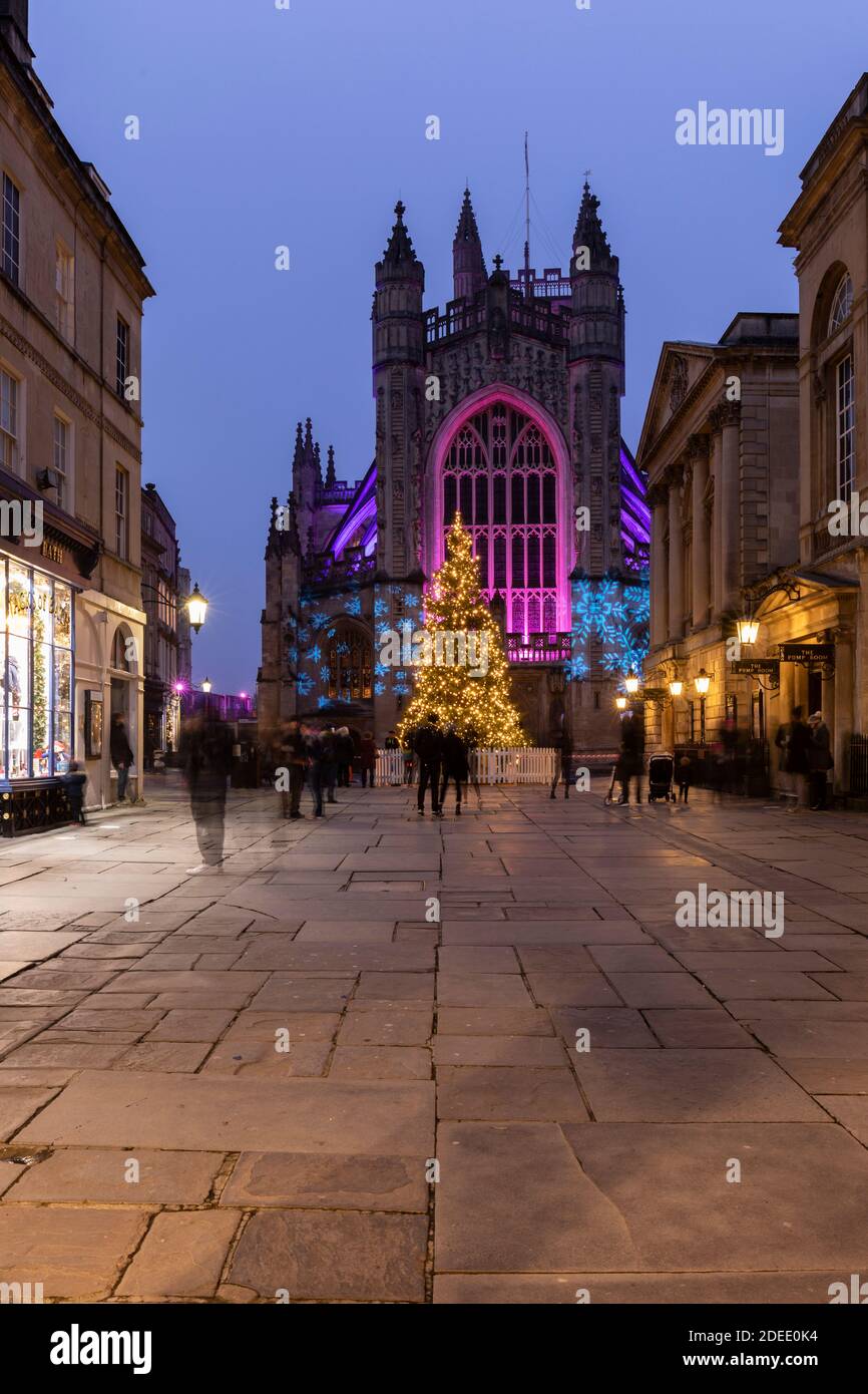 Bath Abbey lit with colourful illuminations and a bright tall Christmas tree. Part of the 2020 Christmas Light Trail in Bath City Centre, England, UK Stock Photo
