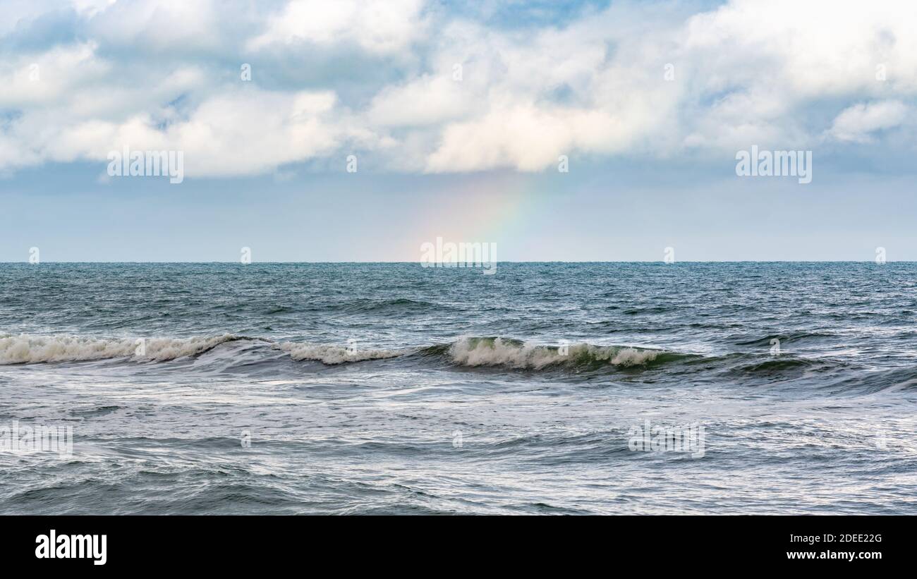 Rainbow over stormy sea after rain Stock Photo - Alamy