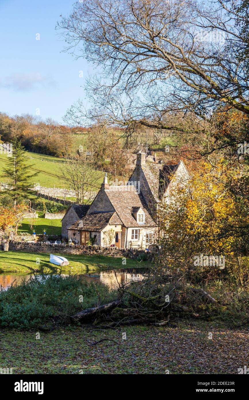 Autumn in the Cotswolds - The small lake on the stream behind Manor Farm at Middle Duntisbourne, Gloucestershire UK Stock Photo