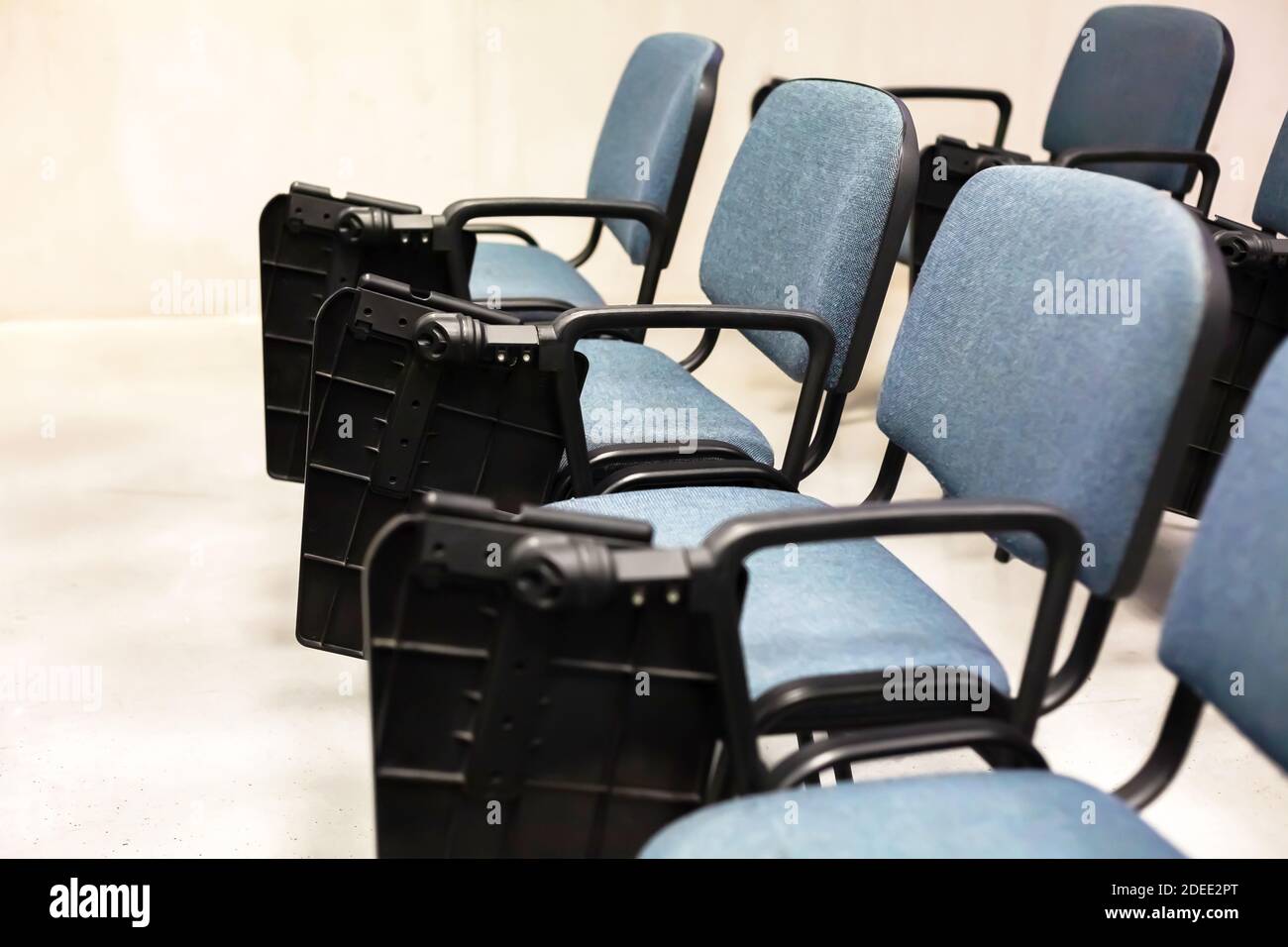 Empty university lecture hall chairs closeup no students present, empty university classroom, auditorium Lockdown, covid 19 quarantine closed facility Stock Photo