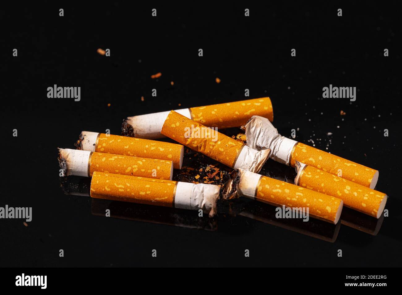 Cigarette butts on black background close up Stock Photo