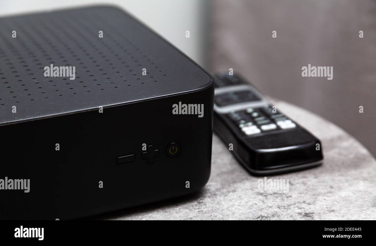 Liberty Global, UPC set top box, black media box and a remote control  laying beside it. TV, polish media provider home equipment, cable television  Stock Photo - Alamy