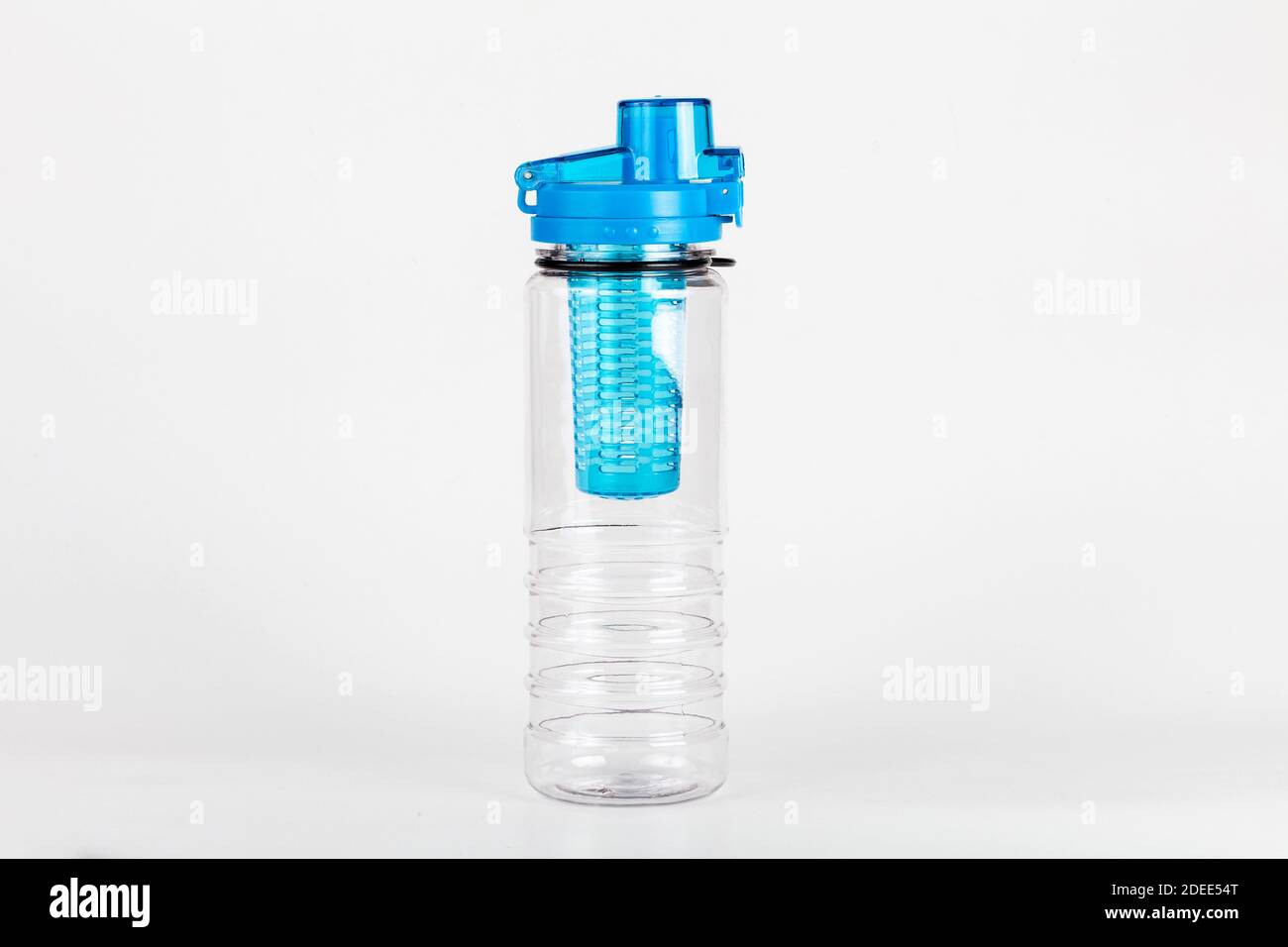 Simple modern empty blue hard plastic sport water bottle with fruit infuser isolated, single object. Blank reusable bottle studio shot. Hydration Stock Photo