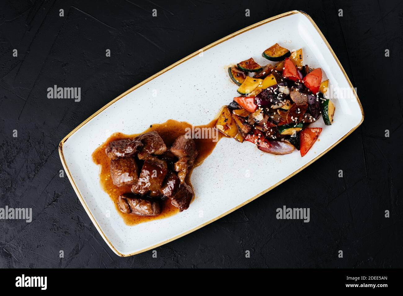beef stew with vegetables on a black background Stock Photo