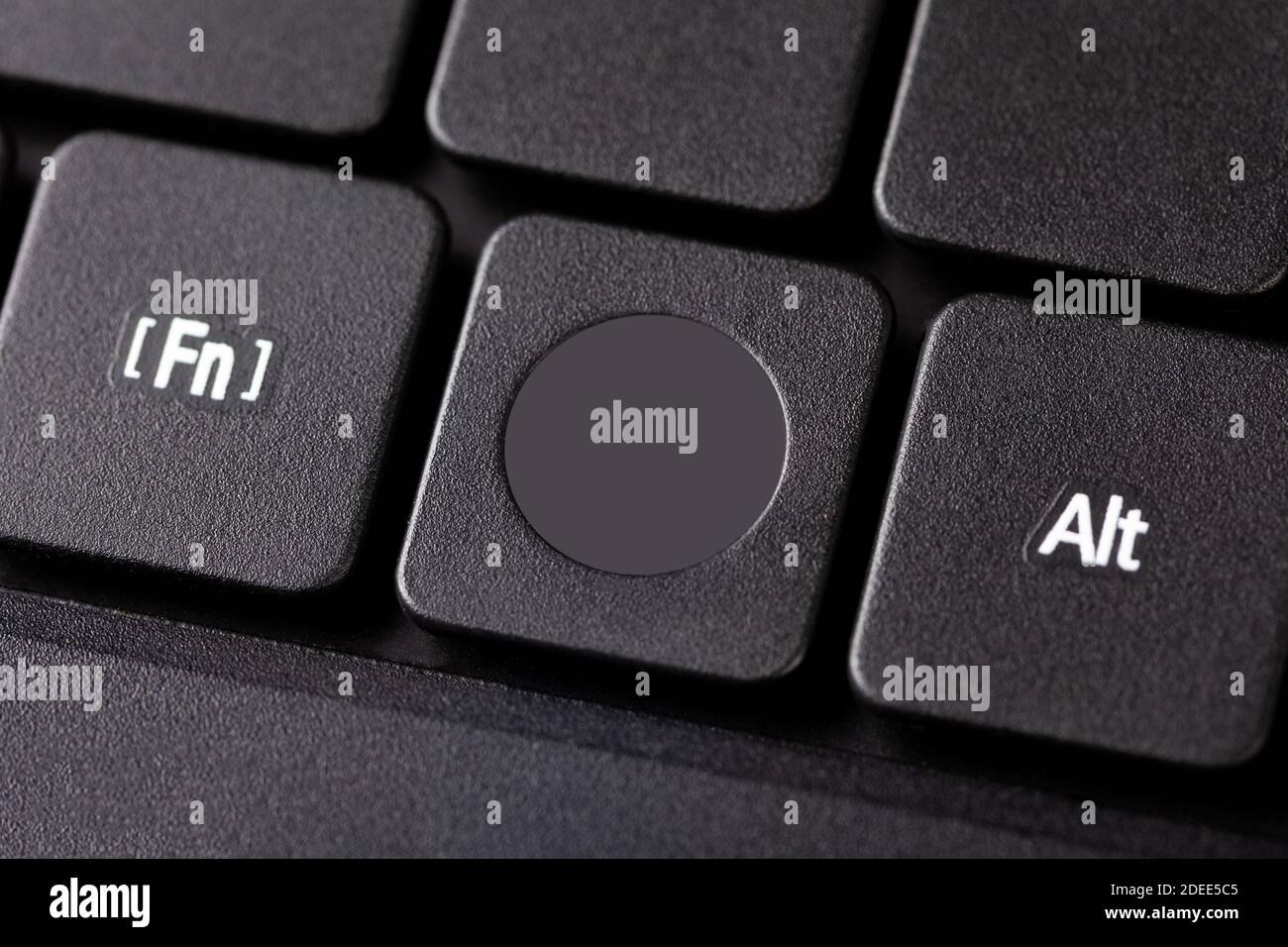 Blank laptop keyboard system key extreme closeup, single empty square button on a black netbook keyboard with nothing on it. Circle symbol, logo space Stock Photo