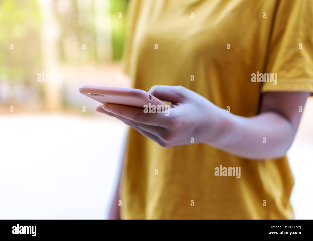 Social network and networking people concept, Hand women with smart phone mobile on blurred bokeh background, Stock Photo