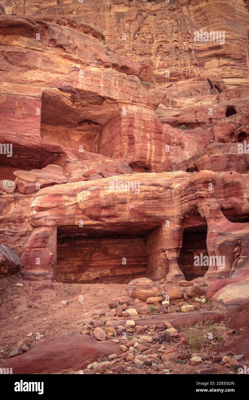 One of many amazing rainbow-coloured hollows of tombs and caves in ancient city of Petra, Jordan Stock Photo