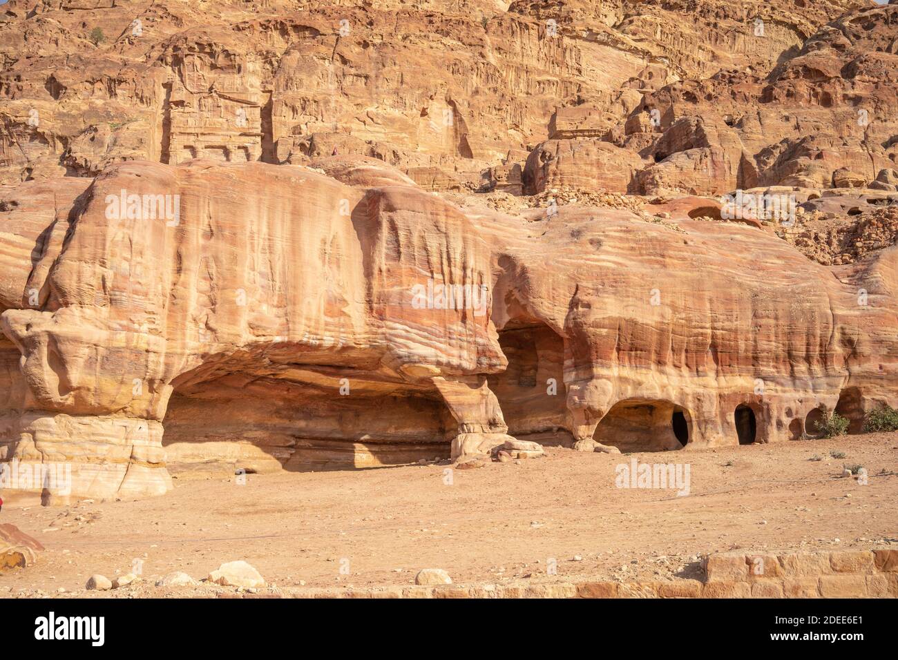 View of Burial caves in ancient Petra city in Jordan. Caves are carved out of sandstone right into the rock. Theme of travel in Jordan. Stock Photo