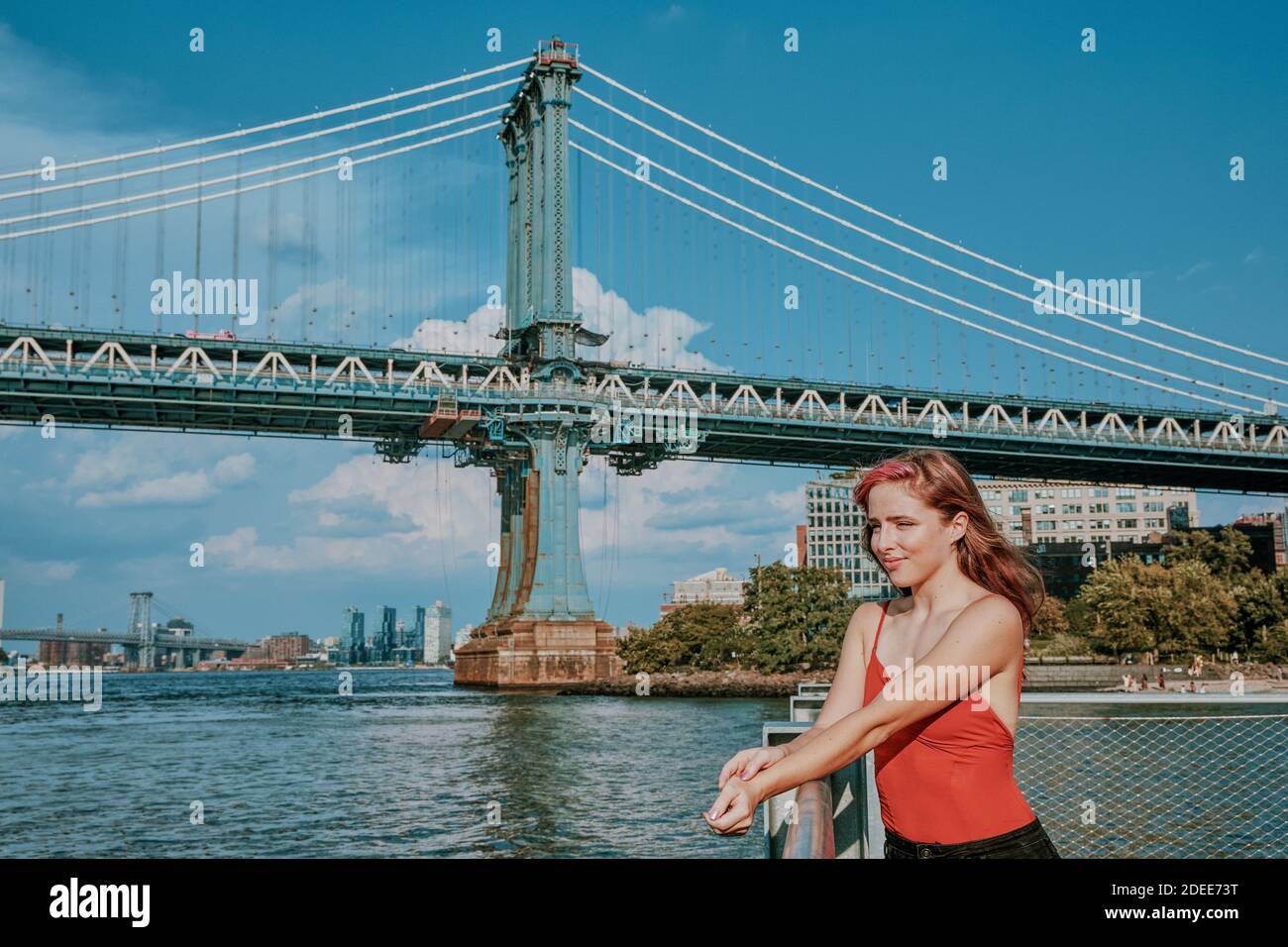 Portrait of a young woman outdoors by river Stock Photo - Alamy