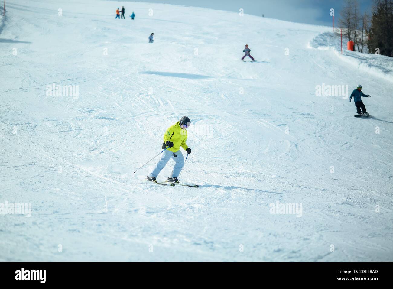 KREISCHBERG, MURAU, AUSTRIA - MARCH 15, 2017: Group of skiers riding the ski slope. Kreischberg is a populer ski resort in Austria Stock Photo