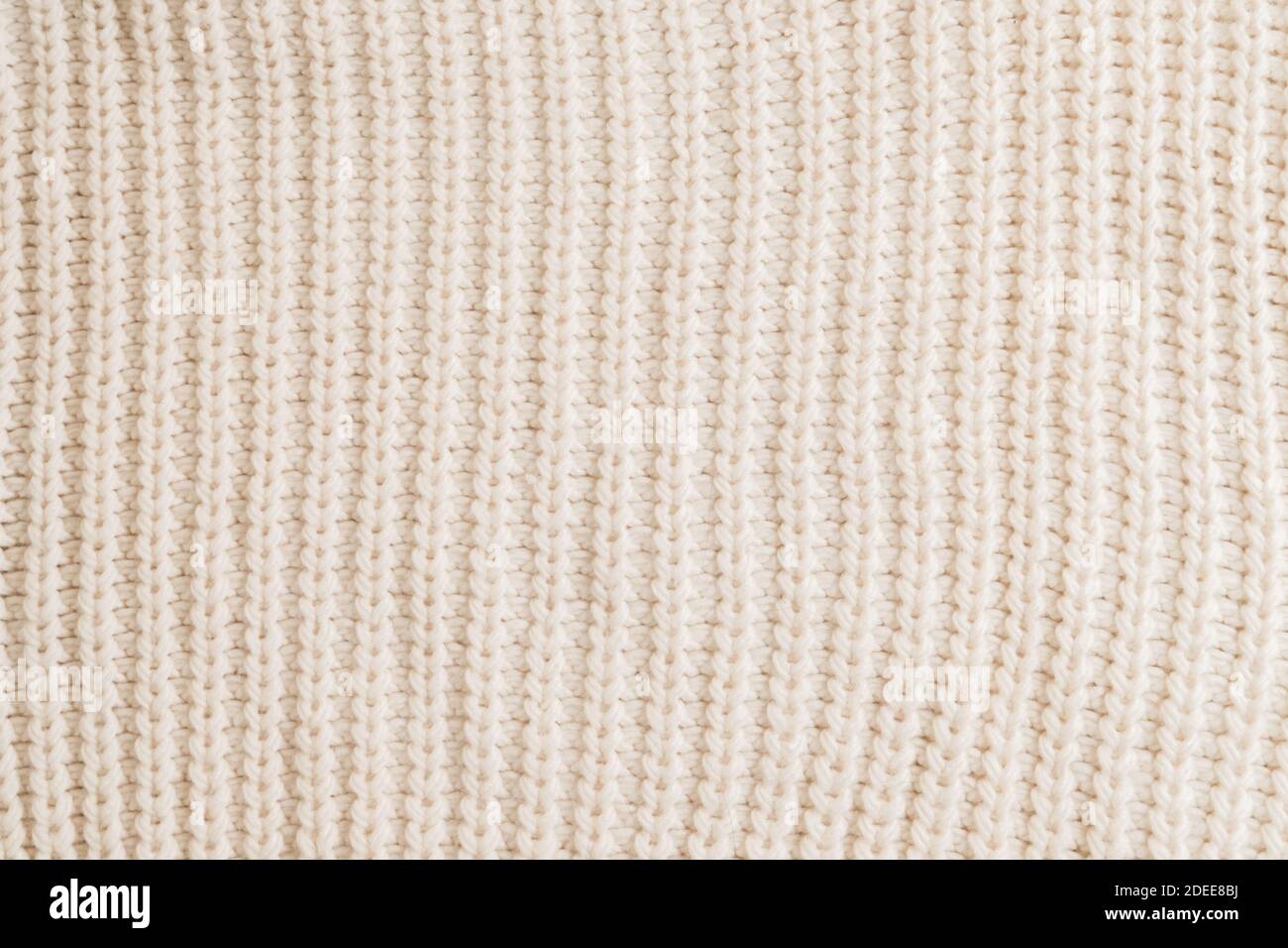 Woolen knitted patterned fabric with folds background texture textile Stock Photo