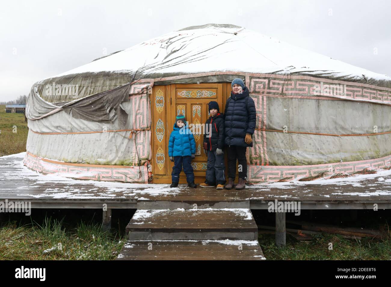 Family in front of Yakut yurt in spring, Russia Stock Photo