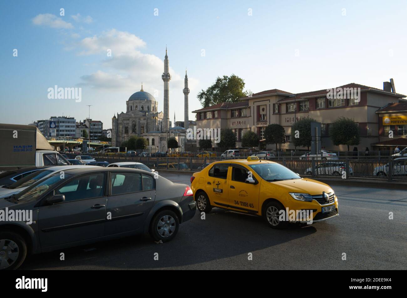 Istanbul, Turkey - September, 2018: Yellow taxi car on the road on a background of mosque. Stock Photo