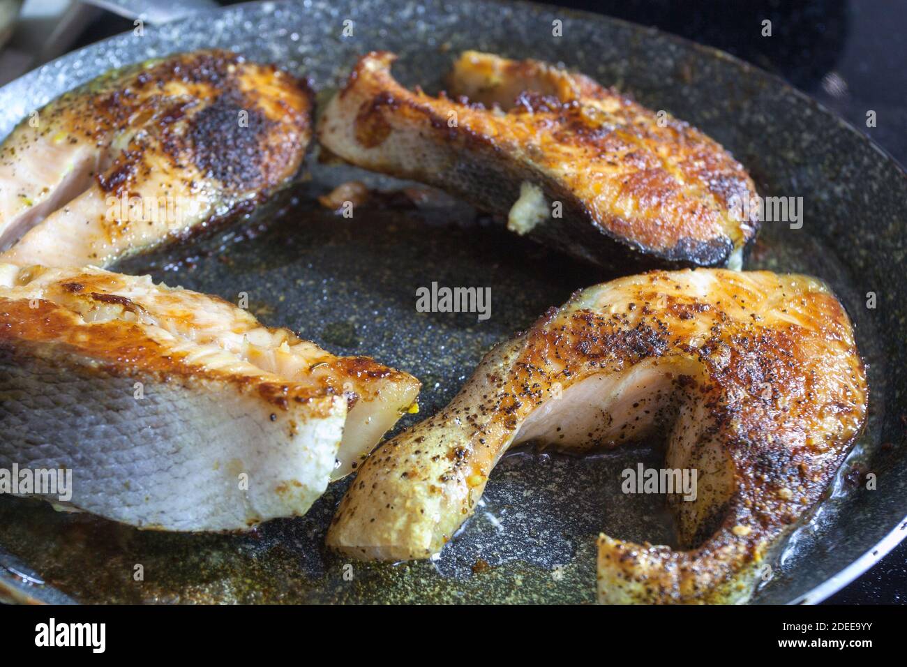 Pan-fried salmon steaks with a golden brown crust Stock Photo - Alamy