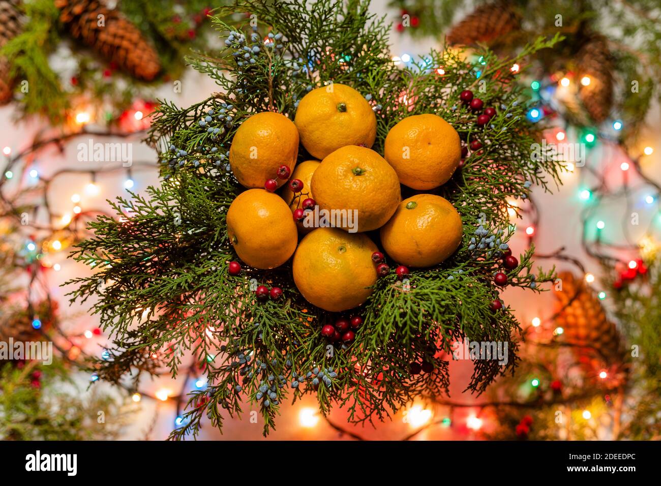 Christmas natural decoration with lots of tangerines in basket and