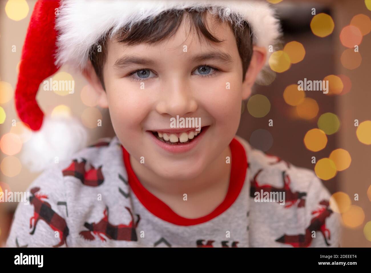 Portrait of a handsome smiling European boy in a red cap Stock Photo