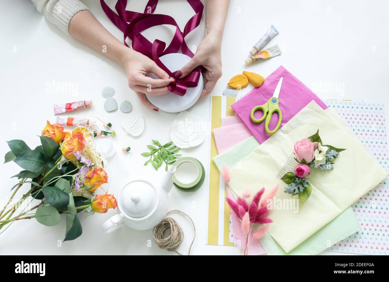 The girl is packing products from handmade artificial flowers.The