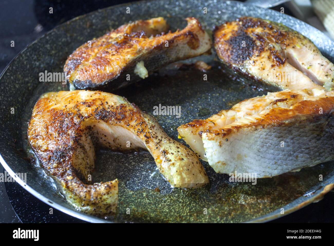 Pan-fried salmon steaks with a golden brown crust Stock Photo - Alamy