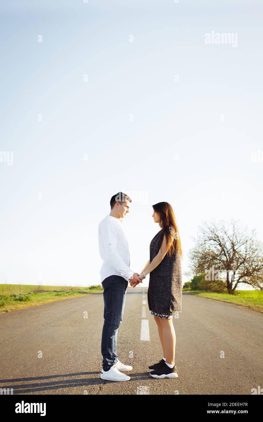 Smiling couple standing together in front of white wall stock photo