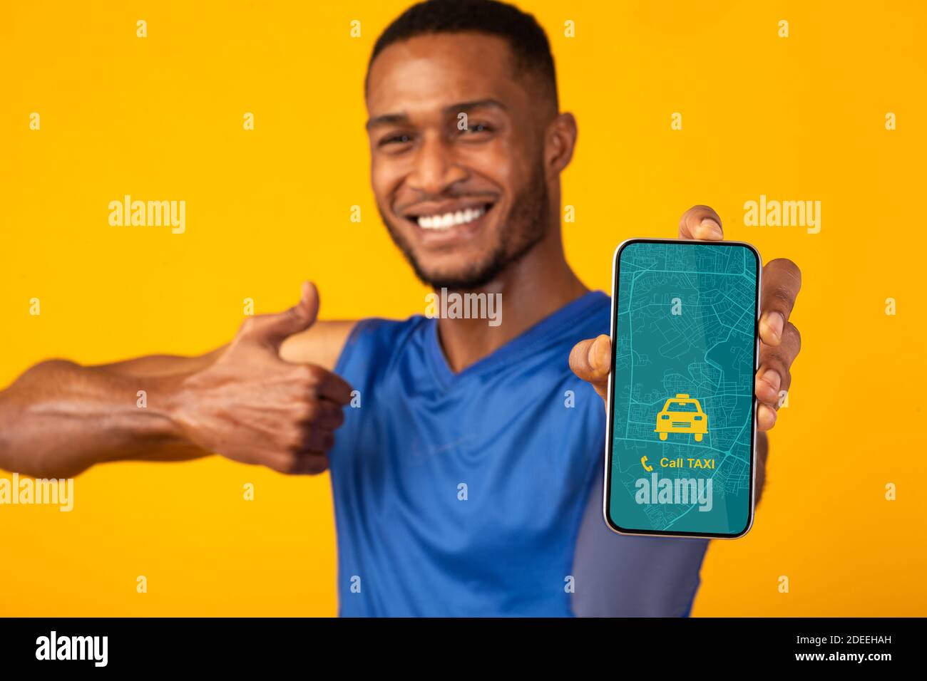 Handsome black guy holding smartphone with opened taxi services mobile