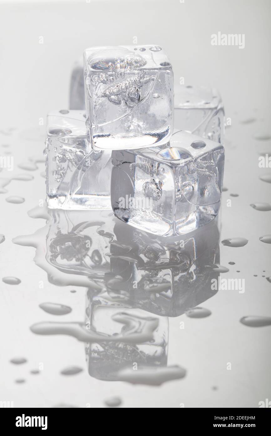 Stack of melting ice cubes in studio Stock Photo Alamy